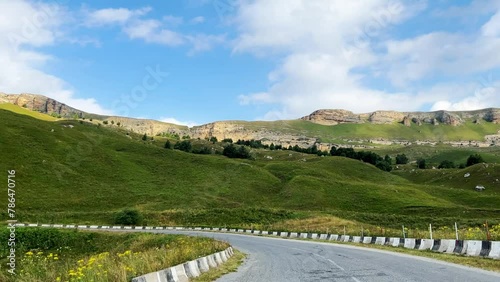 Gumbashi Pass, the highest mountain pass in Russia. The view from the car to the green mountains and hills. Beautiful summer landscape in the North Caucasus. Beautiful epic view of the valley. 4К photo