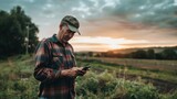 A portrait of the farmer checking weather forecasts on a smartphone before farm activities.
