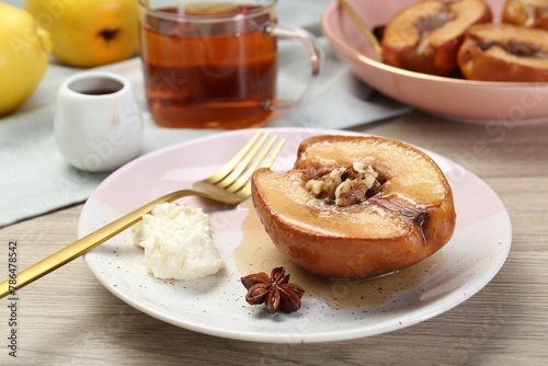 Delicious quince baked with honey and walnuts on wooden table