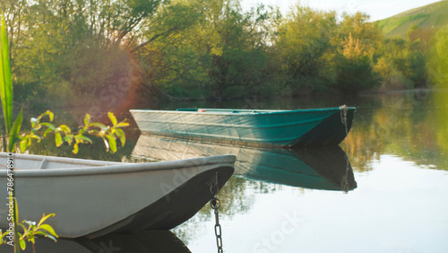 Old metal boats on a quiet lake at sunset. Peace, rest