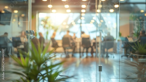 An office scene capturing the cooperation and synergy of business coworkers  with a view through glass into a productive meeting.