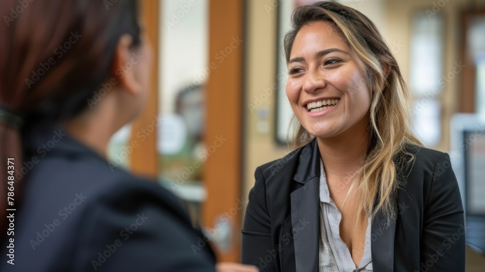 A candid moment of satisfaction as a Hispanic candidate receives congratulations from a businesswoman post-interview. A candid moment of satisfaction as a Hispanic candidate receives congratulations from a businesswoman post-interview.