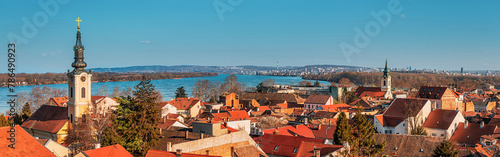 Explore Belgrade's scenic skyline with its iconic red rooftops and historic landmarks, including the belfry and cathedral, offering a picturesque view of the cityscape.