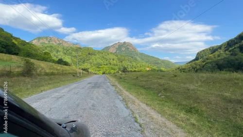 Gumbashi Pass, the highest mountain pass in Russia. The view from the car to the green mountains and hills. Beautiful summer landscape in the North Caucasus. Beautiful epic view of the valley. 4К photo