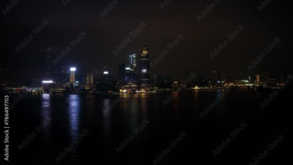 Modern city downtown at night. Apartments, condos and office buildings illumination in Hong Kong aerial view Modern city downtown at night. Apartments, condos and office buildings illumination in Hong Kong aerial view