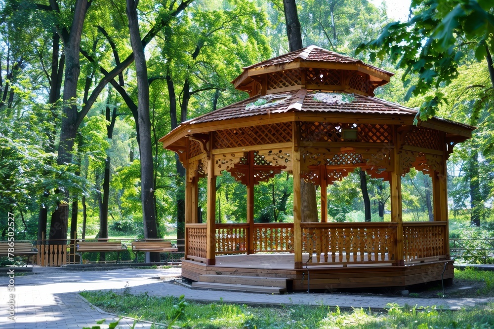 Naklejka premium Tranquil wooden gazebo embraced by the lush beauty of a serene summer park surroundings