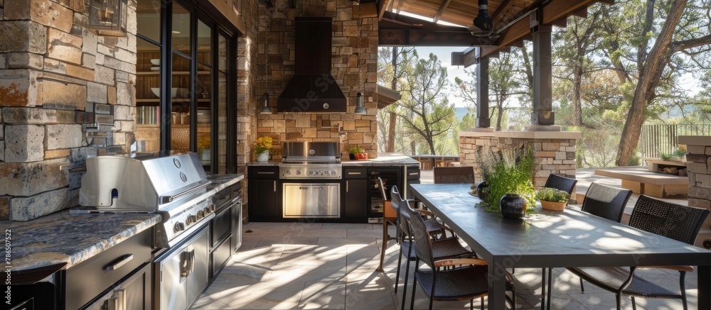 Fototapeta premium Outdoor kitchen with BBQ grill and dining area is perfect for al fresco meals with scenic views.