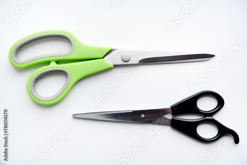 Sewing scissors on a white background. Green scissors.