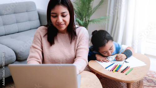 Business Asian mother work with child painting at home. Family love concept