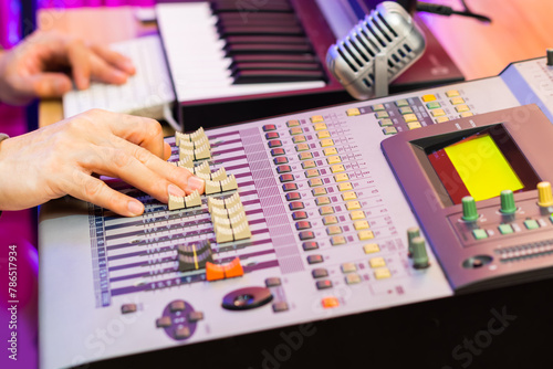 sound engineer, producer hands  working on digital audio mixing console in studio. recording, post production, music production concept