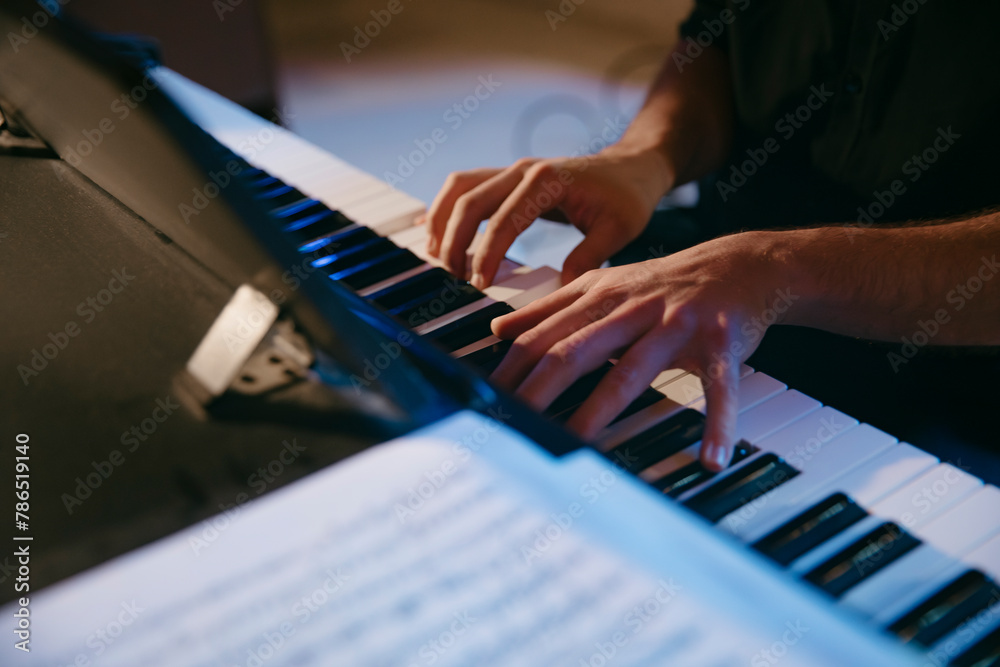 Fototapeta premium person's hands playing a piano