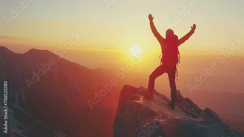 Male hiker climbing the mountain - Strong hiker with hands up standing on the top of the cliff enjoying sunset view 