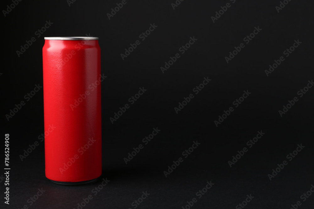 Energy drink in red can on black background, space for text Energy drink in red can on black background, space for text