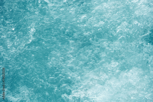 Abstract transparent water texture, bubbling clear water as textured background, purity and beauty of nature, natural ripples and waves on blue turquoise aquatic surface, nature environment