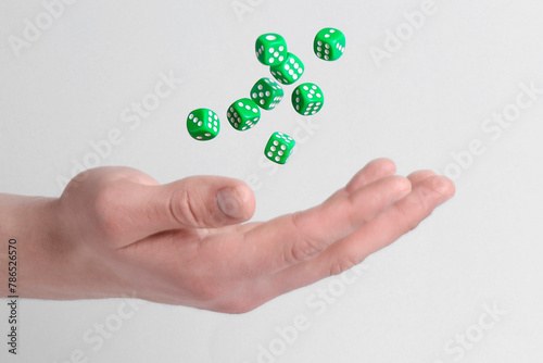 Man throwing game dices on white background, closeup