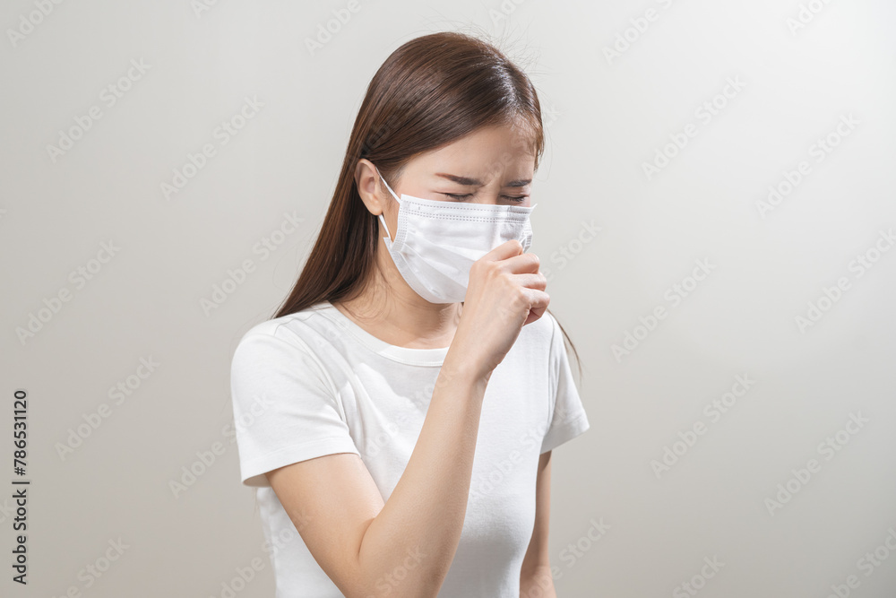 Unhealthy sickness, unwell asian young woman wearing mask coughing, have sore throat, suffering symptom cough feeling bad and healthcare of air pollution and dust, PM2.5 isolated white background. Unhealthy sickness, unwell asian young woman wearing mask coughing, have sore throat, suffering symptom cough feeling bad and healthcare of air pollution and dust, PM2.5 isolated white background.