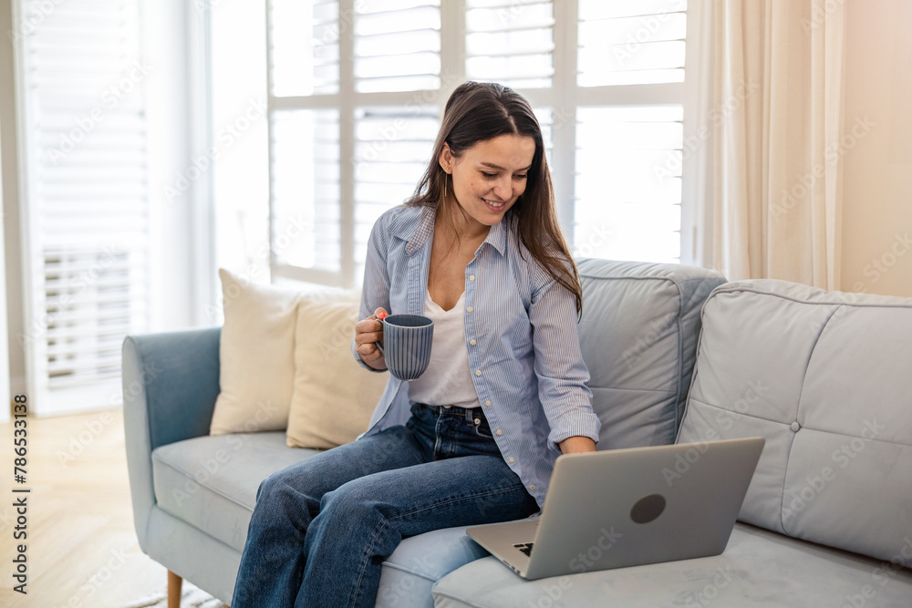 Portrait of smiling woman working on laptop at home
Portrait of smiling woman working on laptop at home