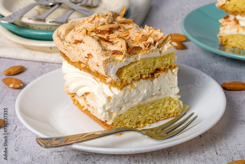 Norwegian cake. With meringue, whipped cream and almonds. Light background.