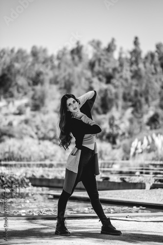 Latina beauty and fashion: beautiful brunette model with a fashion look in a sunny day in the park (in black and white) 