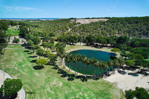 Drone point of view golf course on tropical nature with green lake during sunny summer day. Places, lifestyle, sport concept © Alex Tihonov