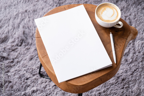 blank magazine mockup on coffee table with cappuccino, pen and grey rug © dark_blade
