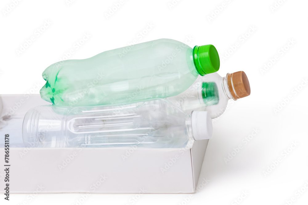 Empty plastic bottles in a box against white backdrop Empty plastic bottles in a box against white backdrop