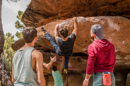 Group of climbers doing boulder climbing photo