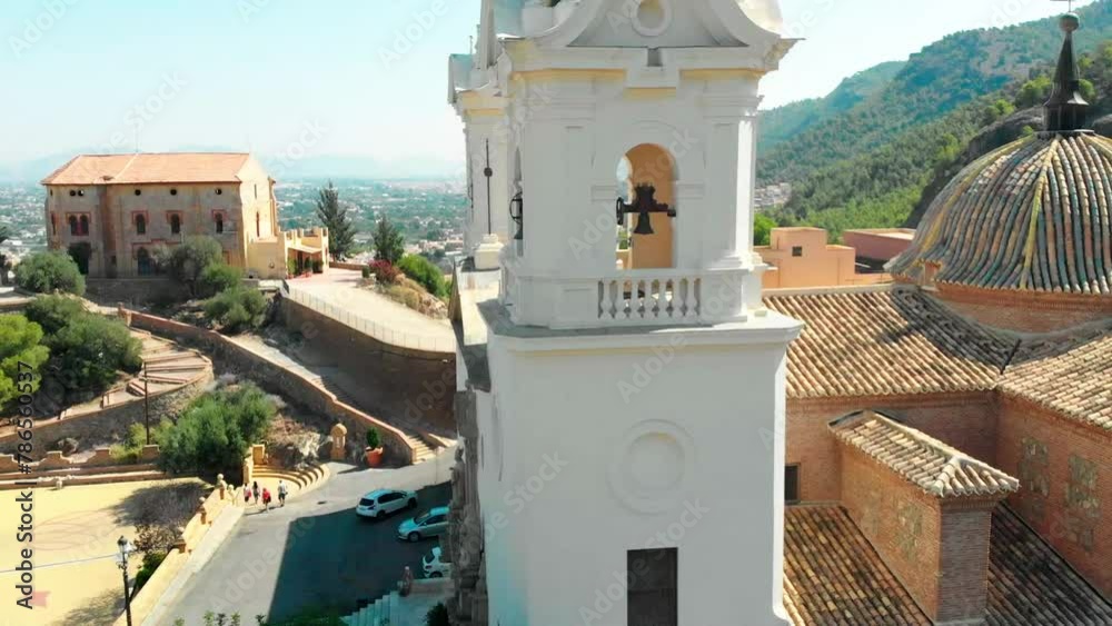 Closeup aerial drone view of the belltowers of Catholic Church Sanctuary of Virgen de la Fuensanta in Murcia, south Spain. Rotating shoot.