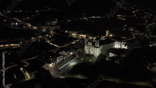 Drone flies over Igreja de Nossa Senhora do Carmo to Praça Tiradentes in Ouro Preto, Brazil at night photo