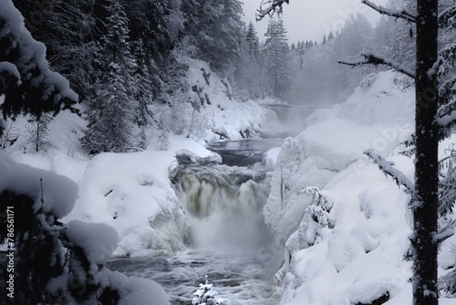 Kivach waterfall in Karelia in winter, waterfall covered with ice and snow