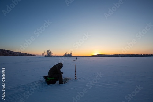 winter fishing in the north, frost at sunset