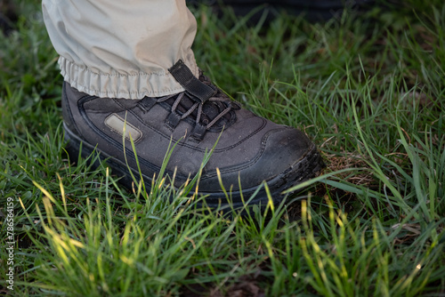 Fisherman's foot in a wading boot on the grass