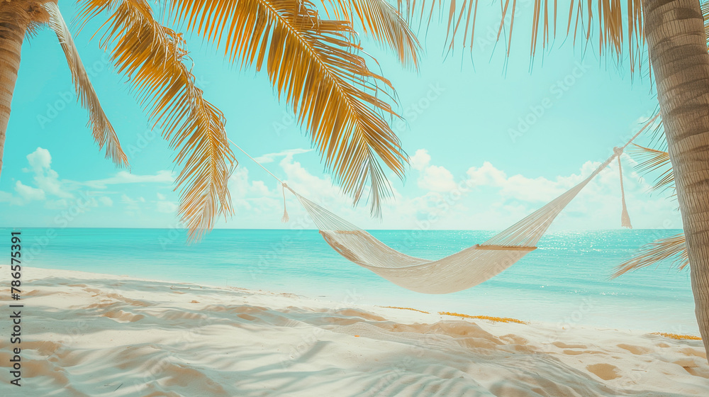 A hammock strung between two palm trees on the beach of an island in the Maldives