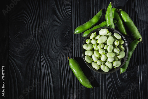 fresh greens broad beans fava on a dark background