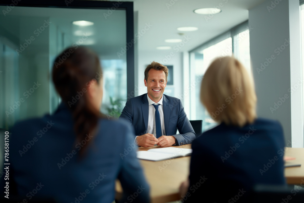 Smiling businessman during conference with colleagues Smiling businessman during conference with colleagues