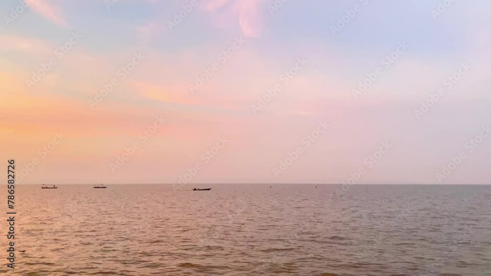 small boat sailing in the middle of the sea at dusk small boat sailing in the middle of the sea at dusk
