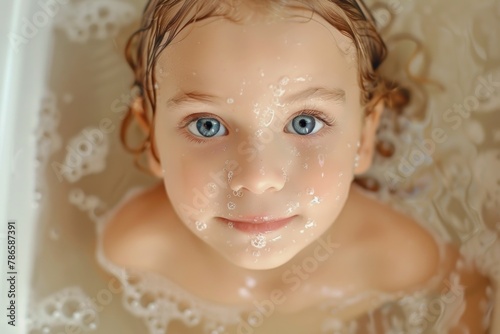 A cute little girl in a bathtub covered in soap. Ideal for hygiene or bath time concepts