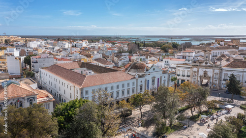 Traditional Portuguese town of Faro on oceanfront with old architecture, filmed by drone. Arco de villa and largo de se.