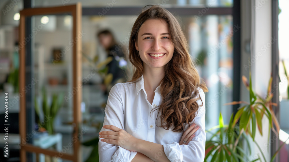 confident young business woman standing with crossed arms and smiling at the office (8) confident young business woman standing with crossed arms and smiling at the office (8)