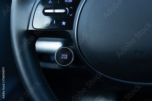 Drive mode button on luxury electric car dashboard. Relaxed and fuel efficient driving mode. Energy-saving button DRIVIE MODE is working while driving, energy-saving driving mode photo