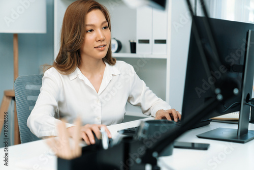 Portrait of beautiful businesswoman working on computer for checking email for sales report highest profit in casual day at modern office in young making startup business challenge concept. Infobahn.