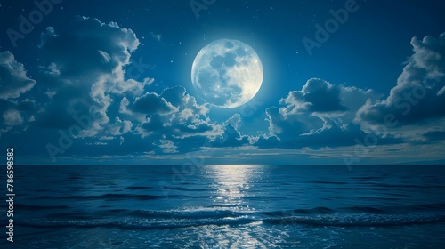 Full moon over the peaceful sea. Night sky with big blue moon rises above the sea among the clouds