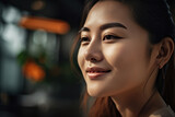 Close-up portrait of a joyful young Asian woman, with a warm smile, perfect for beauty and lifestyle campaigns