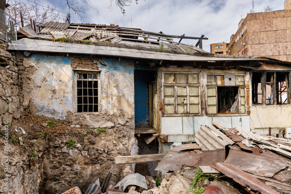 A vintage abandoned house with decayed and wrecked walls