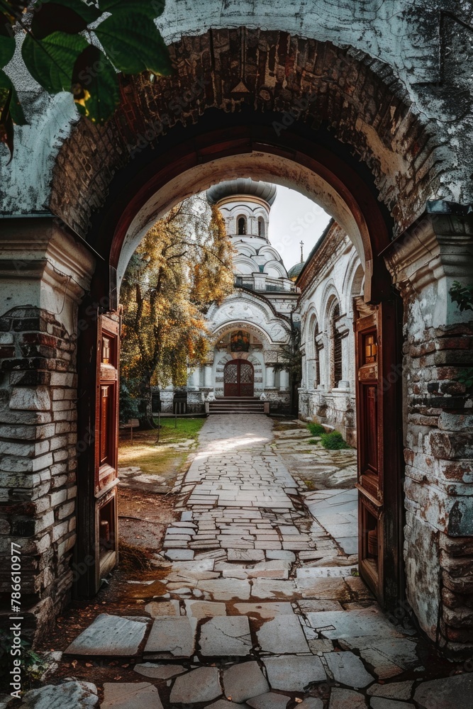 An archway leading to a building with a clock tower. Suitable for architectural concepts An archway leading to a building with a clock tower. Suitable for architectural concepts