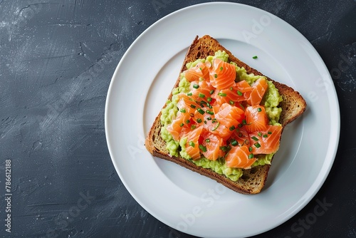Toast bread with salted salmon and guacamole avocado on grey background