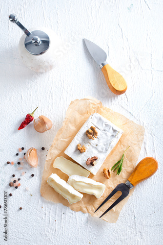 camambert cheese with nuts on white table