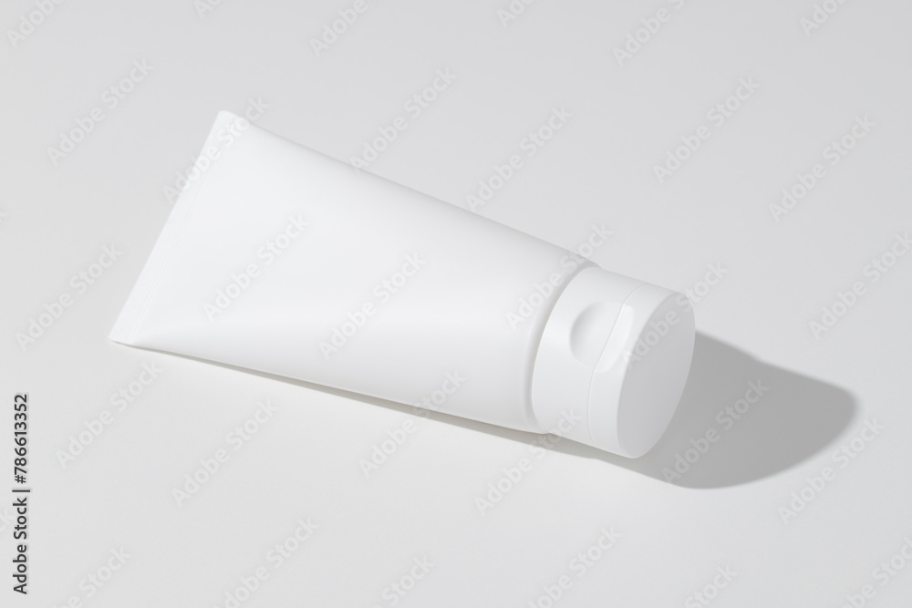 Empty white plastic tube for cosmetics. Mockup. Packaging for cream, gel, serum, advertising and product promotion Empty white plastic tube for cosmetics. Mockup. Packaging for cream, gel, serum, advertising and product promotion