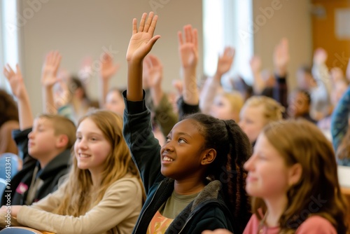 Group of diverse students eagerly raising their hands to participate in a classroom setting