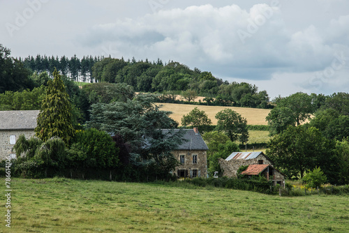 landscape with farmhouse, meadows and trees in the French region of the Auvergne
